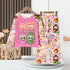 The LABUBU Baby Pajama Set by LABUBU is a cozy, milk silk kids sleepwear ensemble featuring a colorful design with cartoon bunnies, a pink top reading "Exciting Vacation," and pants with a macaron pattern, enhanced by charming macrame decor and a potted plant in the background.