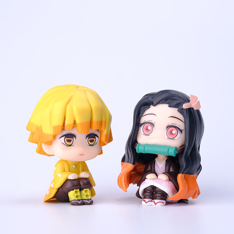 This exclusive Demon Slayer Figure set includes 8 chibi-style PVC figures on a white background. The left figure has yellow hair and outfit, while the right features black-orange hair with a pink bow and green mouthpiece. Perfect for any anime collection or Demon Slayer fan.