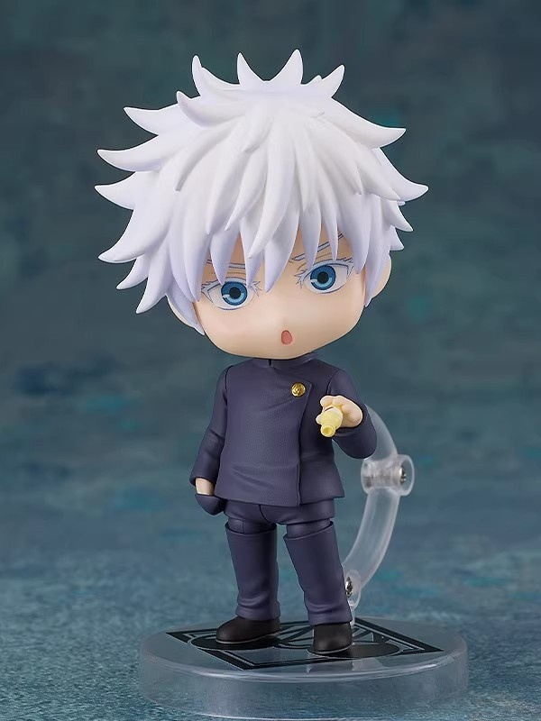 The 12cm Jujutsu Kaisen Gojo Satoru Action Figure features a chibi design with spiky white hair, blue eyes, and a dark outfit. It stands on a circular base with an open-mouth expression and extended hand, set against a textured blue-green background—a must-have anime collectible.