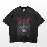 The Solo Leveling Statue of God T-Shirt features a dark anime design with a stylized face, sharp teeth, and intricate lettering. The phrase "Statue of God" is displayed at the bottom, giving the shirt a textured, worn look.