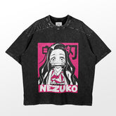A black T-shirt from Demon Slayer featuring a pink and white Pop Art illustration of Nezuko Kamado with long hair and a mouth cover, along with Japanese text and "Nezuko" in bold pink letters.