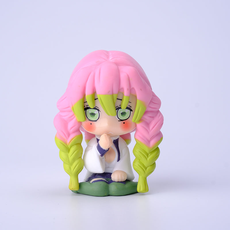 The Demon Slayer Figure Set includes a 7cm chibi-style figurine featuring a character with pink and green braided hair, in a white outfit with a green skirt. With large, green eyes, it&
