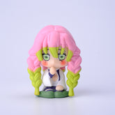 The Demon Slayer Figure Set includes a 7cm chibi-style figurine featuring a character with pink and green braided hair, in a white outfit with a green skirt. With large, green eyes, it&