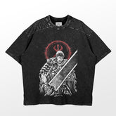 A washed black oversized T-shirt from Berserk features the Guts "Dragonslayer Rage" design, depicting an armored warrior with the iconic sword and a red three-pronged symbol. The mottled texture captures the dark essence of Berserk&