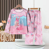 The LABUBU Baby Pajama Set - "Exciting Macaron" features a pink milk silk fabric adorned with playful patterns. It depicts a cartoon character with a cotton candy-like object, capturing childhood whimsy in its long-sleeve top and pants.