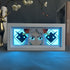 The Seakoff Yamato One Piece 3D LED Light Box, an anime collectible lamp with 16 colors, showcases a character with long hair and horns against a blue geometric background. Nearby, a deer figurine and the book "Nathalie" enhance the anime-themed decor.