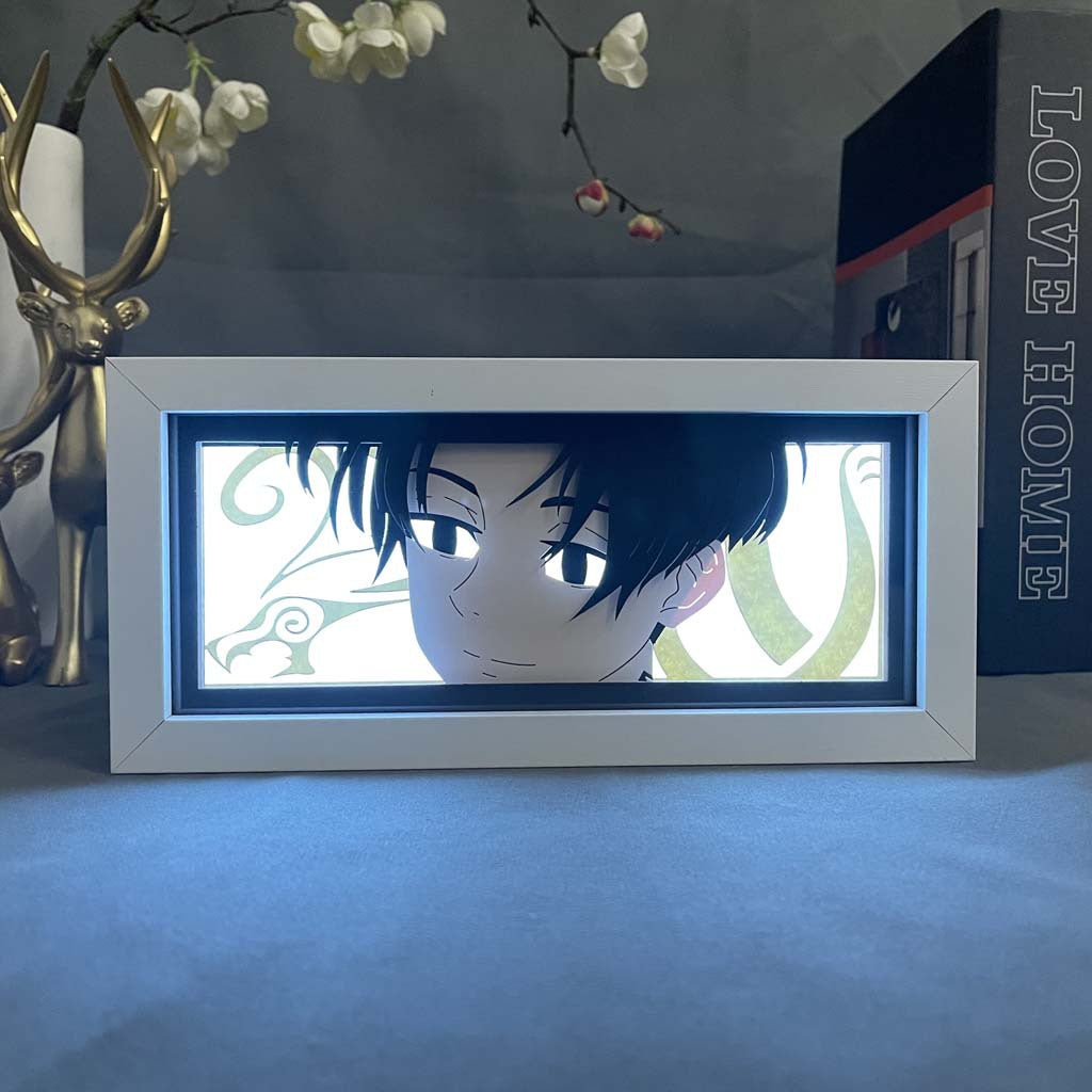 The Yuta Okkotsu 3D LED Light Box from Jujutsu Kaisen features a dark-haired character with a neutral expression. A decorative golden deer figurine stands to the left, and a "LOVE HOME" book is on the right, all set against a subtly patterned background.