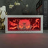 The Sukuna LED 3D Light Box – Jujutsu Kaisen Cursed Energy Glow features an anime character with intense eyes and spiky hair, engulfed in red flames. A white frame contrasts the decor, with "LOVE" on the side. Ideal for fans and collectors of Jujutsu Kaisen seeking a striking piece.