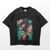 The Eren Yeager Dual Form Attack on Titan T-Shirt features an intense anime design with two characters on a black short-sleeve. One is larger and muscular with dark hair, while the other is smaller and serious, set against a vibrant green background. Brand: Attack on Titan.