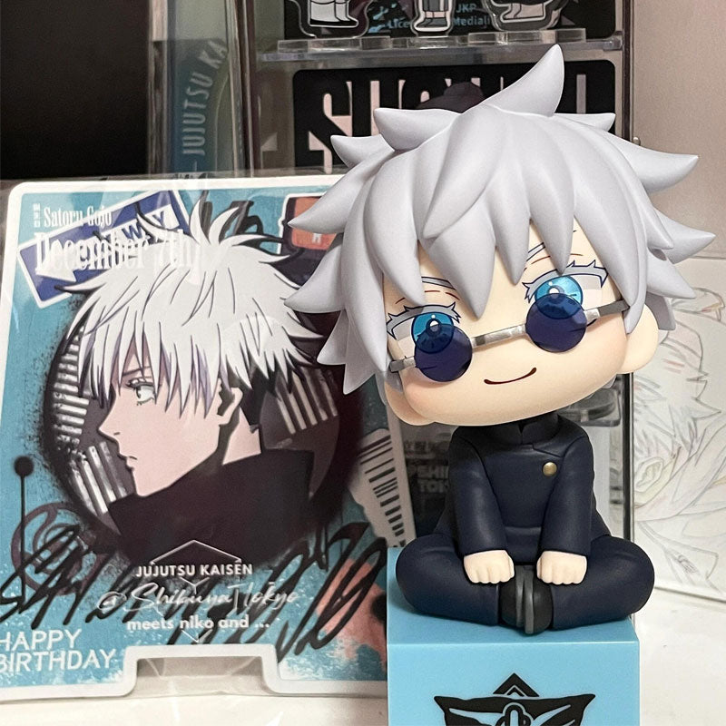 The "Gojo Satoru Anime Figure" features a 12cm collectible action figure with silver hair and glasses, sitting cross-legged before a decorated card. Celebrating "Jujutsu Kaisen" and birthday greetings, it&