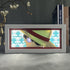 The Seakoff One Piece Anime Light Box features Monkey D. Luffy with a straw hat and determined expression in illuminated artwork. It boasts a 3D anime effect, adjustable 16-color LED lights, and subtle book visibility against repeating cartoon pirate symbols in the background.