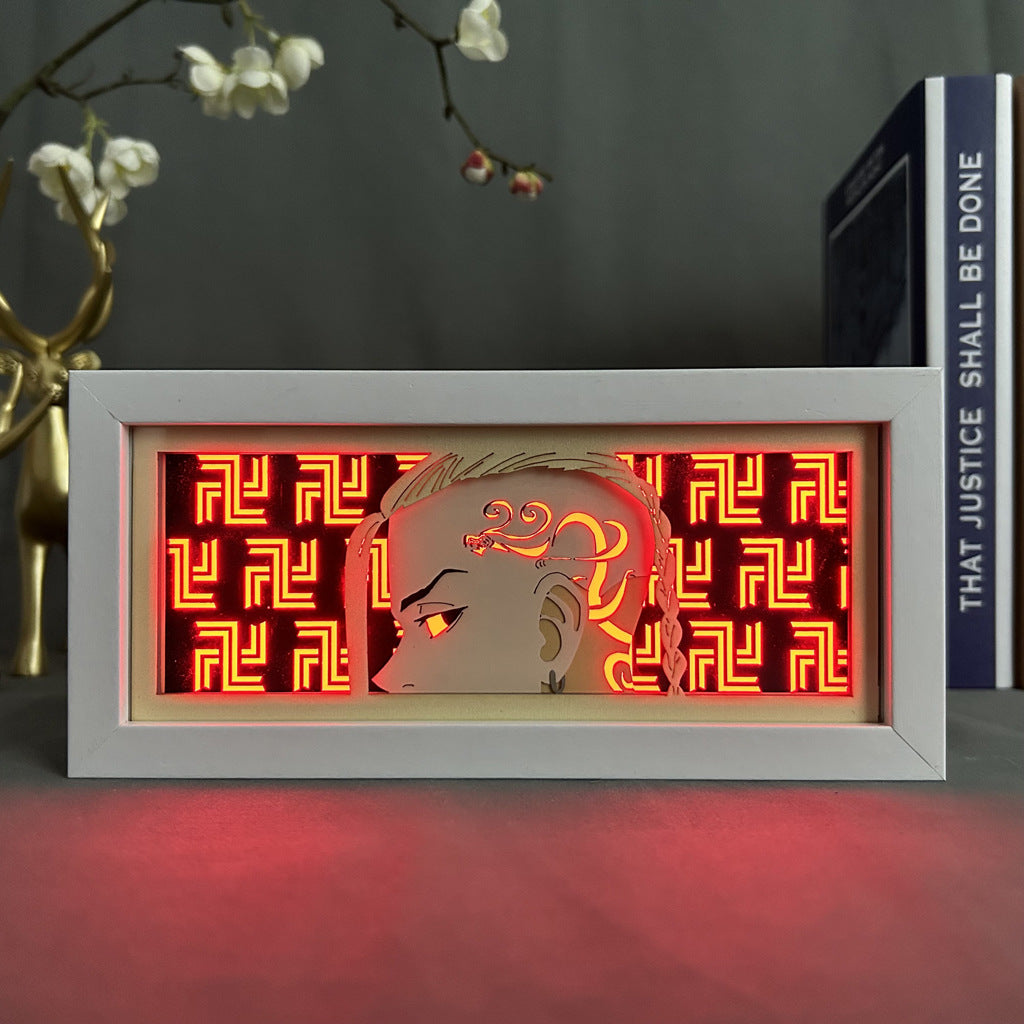 The Tokyo Revengers Anime Light Box features Manjiro "Mikey" Sano in a 3D effect with intricate hair designs, set against a glowing red geometric background. This 16-color adjustable LED light includes decorative elements reminiscent of an anime display.