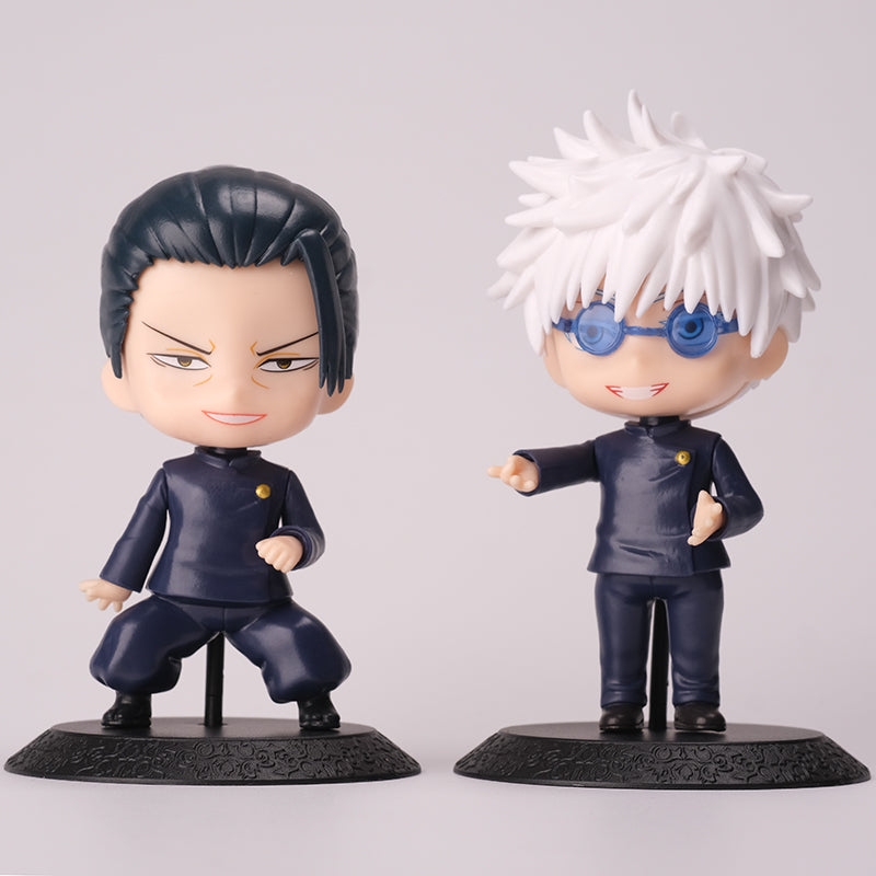 Two chibi-style figures from the Gojo Satoru & Suguru Geto 10-Piece Action Figure Set stand on bases, perfect for any anime collection. One features short dark hair and a confident expression, while the other resembles an action figure with spiky white hair, blue glasses, and a smile. Both wear dark uniforms.