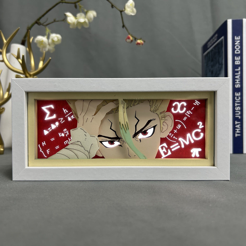 The Seakoff Dr. Stone Anime Light Box features a 3D effect of Senku Ishigami with intense eyes, hand on forehead, surrounded by mathematical symbols like Σ, π, and E=mc² against a red backdrop. A decorative plant and book are partially visible. It offers 16-color adjustable LED lighting.