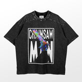 The Chainsaw Man Holographic Blade T-Shirt is a black anime tee with a colorful chainsaw graphic and bold white "CHiANSAW MAN" text. It boasts a speckled texture, relaxed fit, and features a unique holographic blade design. Made of 100% cotton anime apparel by Chainsaw Man.