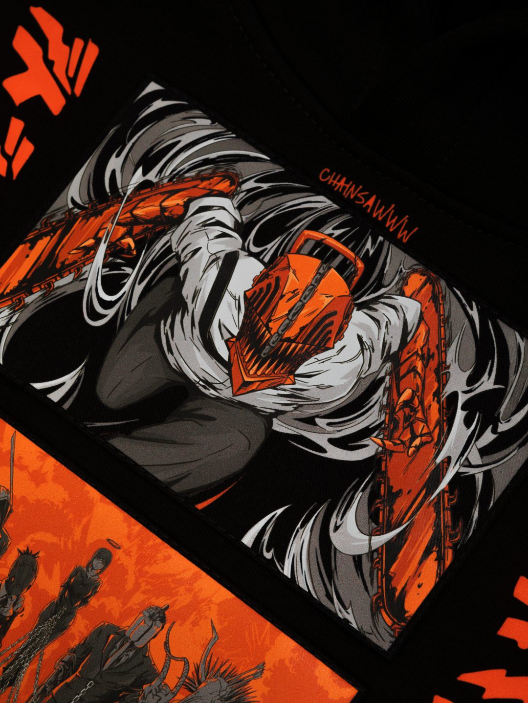 This high-quality Chainsaw Man hoodie, made of 360 GSM cotton, showcases a character with a red chainsaw head and arms amidst dynamic black and white lines, with bold orange elements and "Chainsaw Man" text—ideal for anime fashion enthusiasts or streetwear collections.