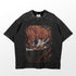 A black cotton Bleach Shirt featuring a sword-wielding figure in white, surrounded by swirling flames. It has a speckled texture and short sleeves, making it ideal for summer wear.