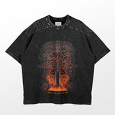 The Berserk "Usurp the Hand of God" oversized tee in washed black features a dark fantasy graphic design with a winged figure, sword, flames, and intricate patterns. The edgy aesthetic is completed with "UNDER THE HAND OF GOD" at the bottom.