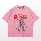 The Berserk Guts Washed Vintage T-Shirt, a pink oversized anime streetwear piece by Berserk, features a bold black and red graphic of Guts in his armor with a massive sword. "Berserk" is displayed in striking red letters above him, complemented by Japanese text for an edgy look.