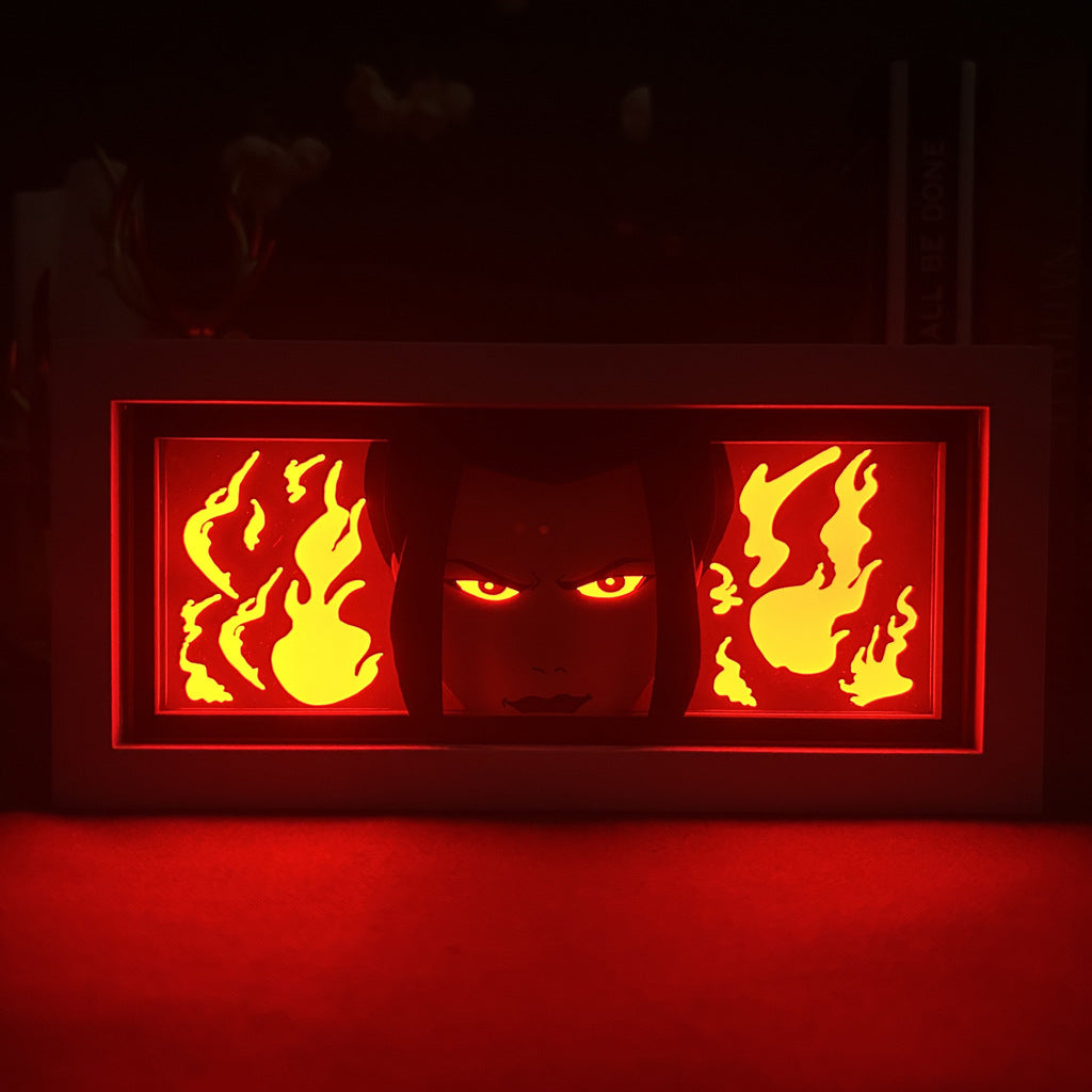 The "Avatar: The Last Airbender Anime Light Box – Azula 3D LED Lamp with Dynamic Color-Changing Effects" by Avatar the Last Airbender illuminates a rectangular frame with red light, showcasing a stylized face and flames, perfect for adding anime-themed decor to any room.