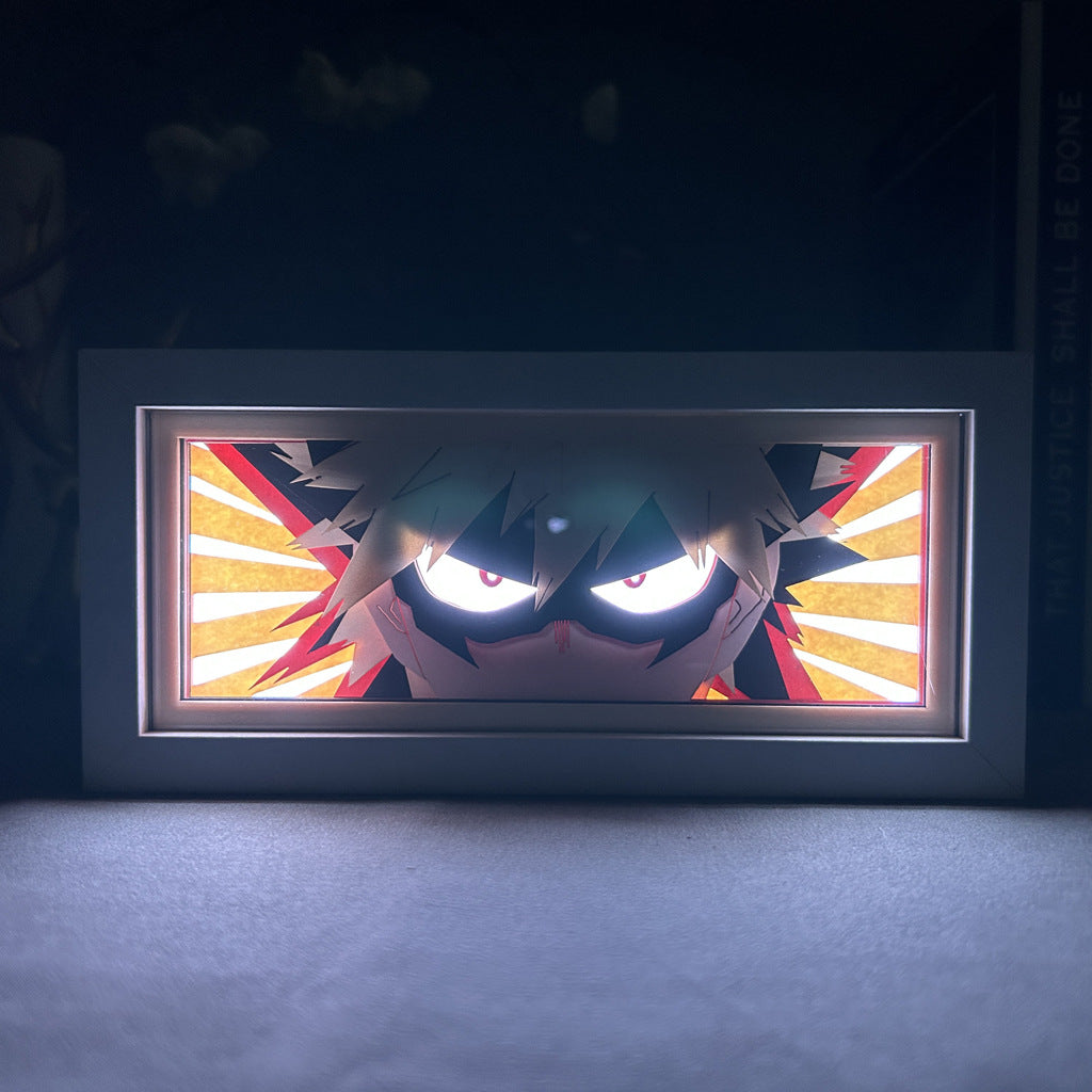 The My Hero Academia Anime Light Box, a Katsuki Bakugo 3D LED Lamp, features dynamic color-changing effects showcasing the spiky-haired character with a mask against red and white radial lines, enhancing dramatic lighting.