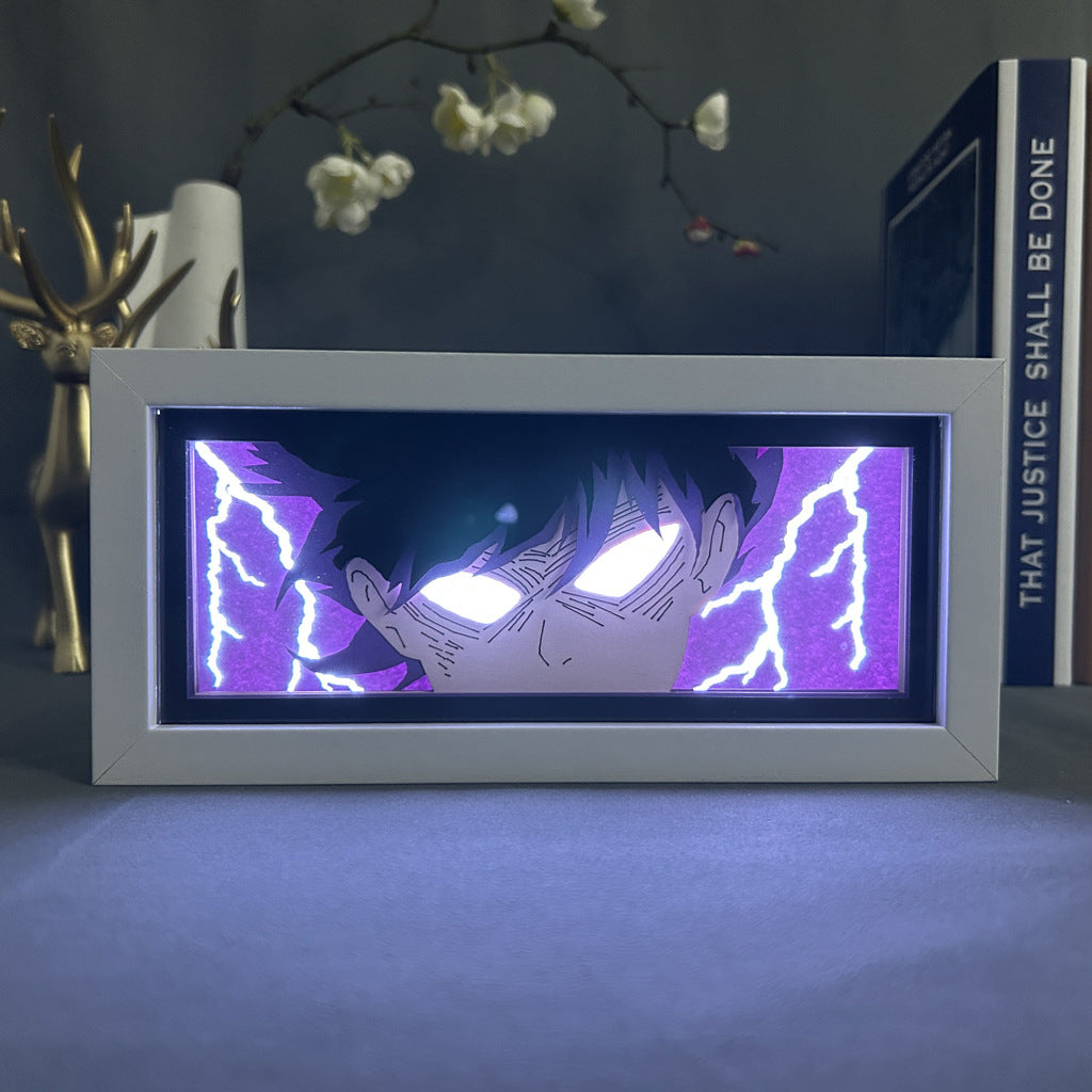 The Mob Psycho 100 Anime Light Box features Shigeo Kageyama (Mob) as a 3D LED lamp with dynamic color-changing effects, showcasing intense glowing eyes and purple lightning, styled with decorative flowers and a book background.