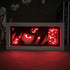 The Naruto Anime Light Box – Itachi Uchiha 3D LED Lamp by Naruto displays Itachi with intense eyes among red shapes. Silhouetted branches with white flowers are in the background, alongside a book labeled "THAT JUSTICE SHALL BE DONE," enhanced by dynamic color-changing effects.