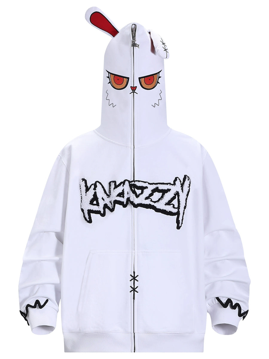 The Seakoff Fierce Bunny Hoodie features a stylized face with red eyes and a unique rabbit ear hood design. It includes graffiti-style text on the front, decorative cuffs, and two front pockets, perfect for an oversized fit, made from 400GSM cotton.