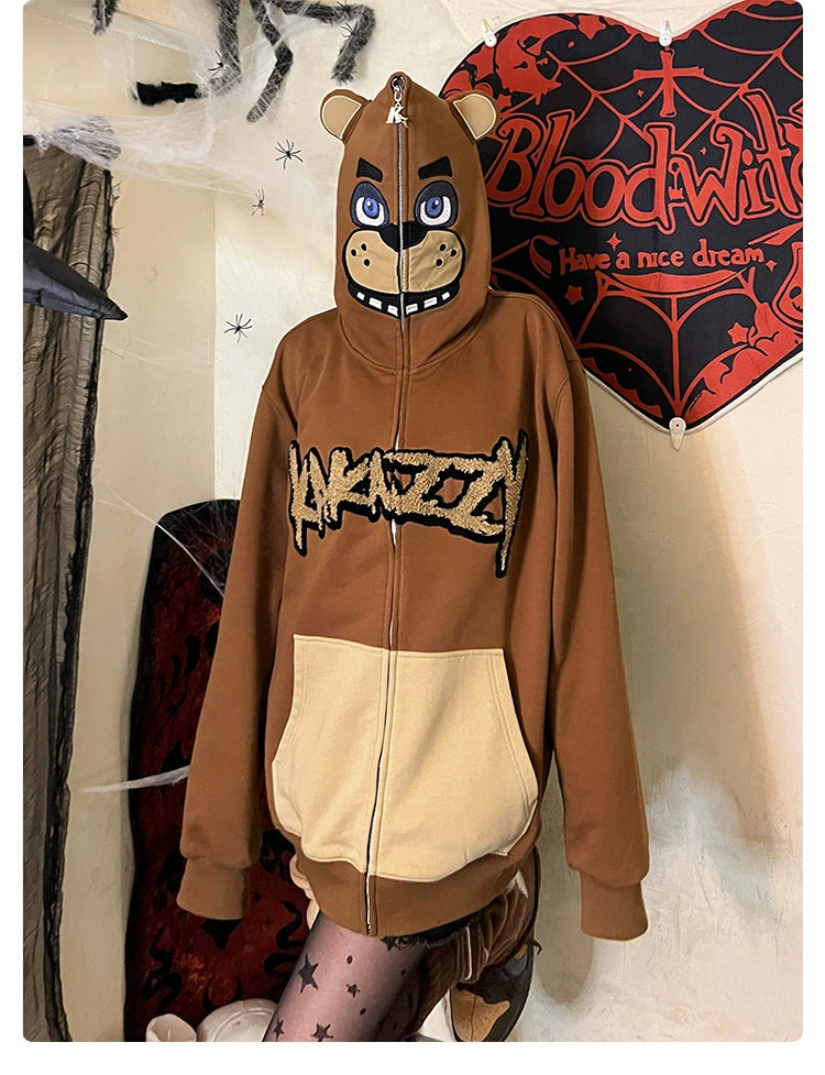 A person is wearing a Seakoff Freddy-Inspired Hoodie, an oversized brown zip-up Five Nights at Freddy&