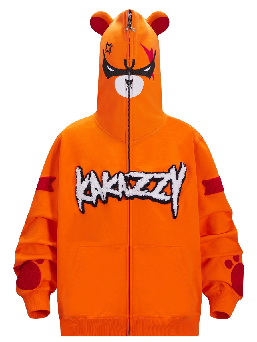The Seakoff Furious Orange Bear Hoodie features an Angry Bear Face cartoon with ears on the hood, a center zipper, bold "KAKAZZY" across the front, and vibrant red sleeve patch designs. It&