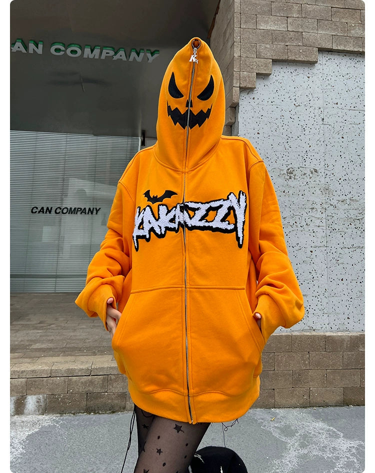 A person in a Seakoff Halloween Pumpkin Hoodie - a 400GSM oversized orange zip-up sweatshirt with a Jack-o&