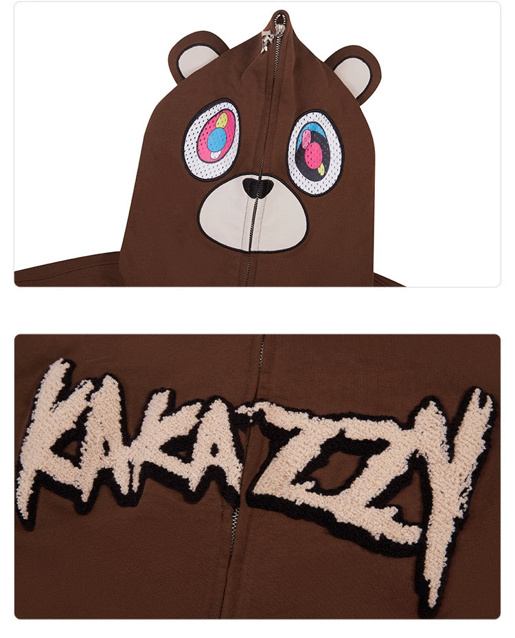 The Cute Bear Hoodie by Seakoff is a 400GSM oversized brown zip-up streetwear sweatshirt, featuring a bear-themed hood with colorful eyes and round ears, and bold "KAKAZY" text on the back.