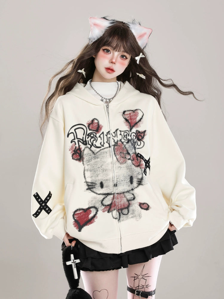 A person with long hair wears cat ears and a Seakoff Gothic Hello Kitty Princess Hoodie—an oversized zip-up featuring edgy heart and cross graphics. They complete the kawaii look with a short black skirt and a small bag adorned with a cross design.