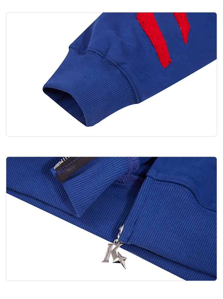 A close-up of the Seakoff Superhero Spider Hoodie showcases two details: the sleeve cuff with red stripes and the hem adorned with a star-shaped metal zipper pull.