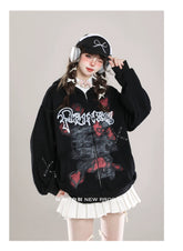 Dressed in a Seakoff Gothic Hello Kitty Princess Hoodie with edgy heart and cross graphics, headphones, and a black cap, a person poses with one hand on their hat. With braided hair over a white collared shirt and pleated skirt, they perfectly blend kawaii style with an alternative twist.