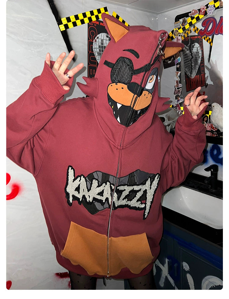 A person is wearing a Seakoff Foxy-Inspired Hoodie, an oversized red zip-up sweatshirt with ears and sharp teeth on the hood. Perfect for Five Nights at Freddy&