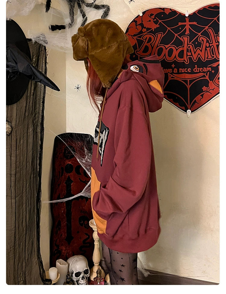 A person wearing a brown furry hat and a Seakoff Foxy-Inspired Hoodie—an oversized red zip-up sweatshirt from Five Nights at Freddy&