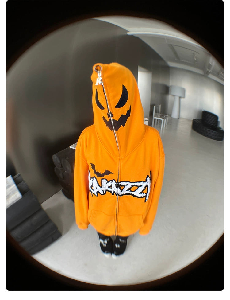 A person wearing a Seakoff Halloween Pumpkin Hoodie - a 400GSM oversized orange zip-up sweatshirt with a jack-o&