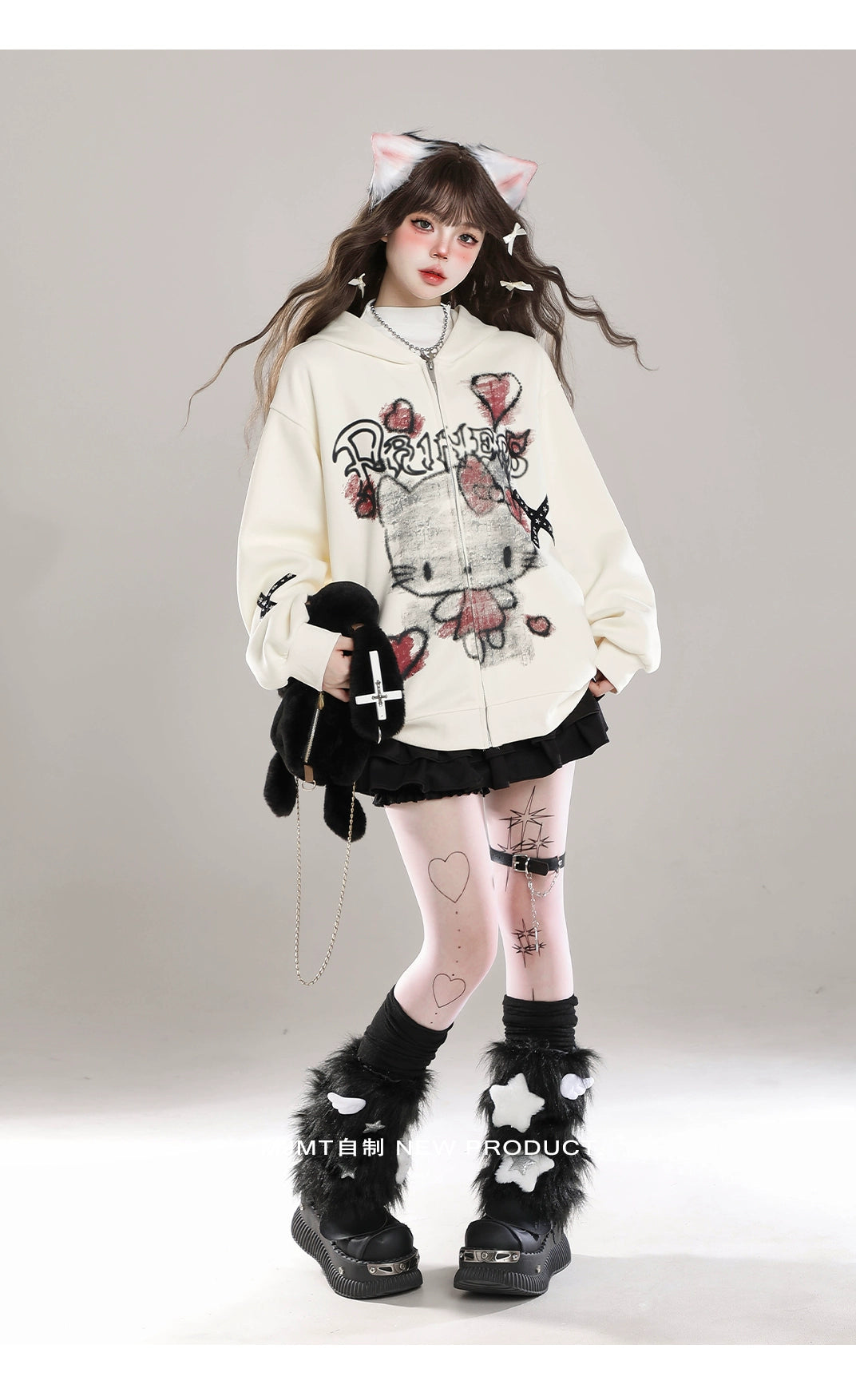 A person with long hair against a plain background showcases kawaii fashion, donning cat ears, a Seakoff Gothic Hello Kitty Princess hoodie featuring edgy heart and cross graphics, a black pleated skirt, heart-patterned white tights, furry boots, and holding a plush toy for an alternative playfulness.