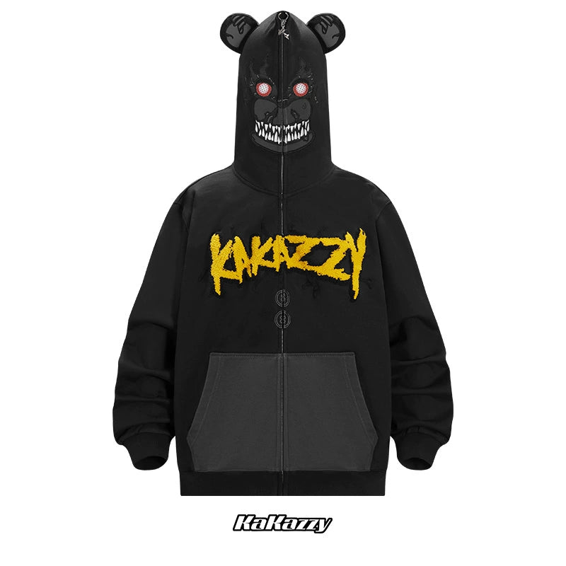 The Seakoff Dark Bear Demon Hoodie is a black 400GSM cotton hoodie featuring yellow "KAKAZZY" embroidery across the chest, bear ears, red eyes, and a menacing white grin—ideal for horror fans.