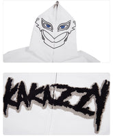 The top image features the Berserk Griffith-Inspired Hoodie, a white oversized zip-up with a stylized face and blue eyes on the hood. The bottom image shows "KAKAZZY" in bold black letters on the back, ideal for anime fans seeking unique merchandise.