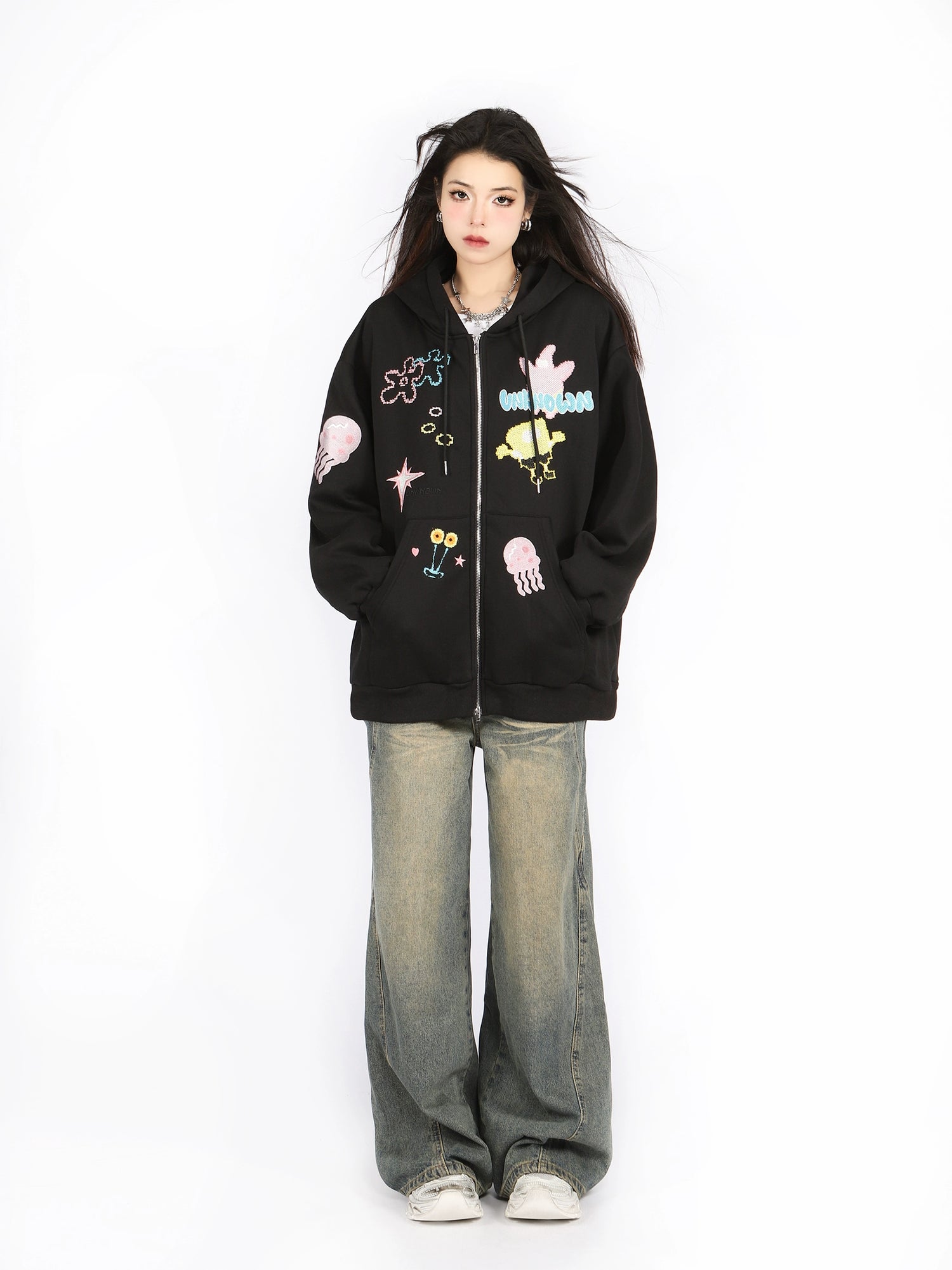 Against a plain white background, a person showcases their anime-inspired fashion with long dark hair, white sneakers, and baggy jeans while wearing Seakoff&