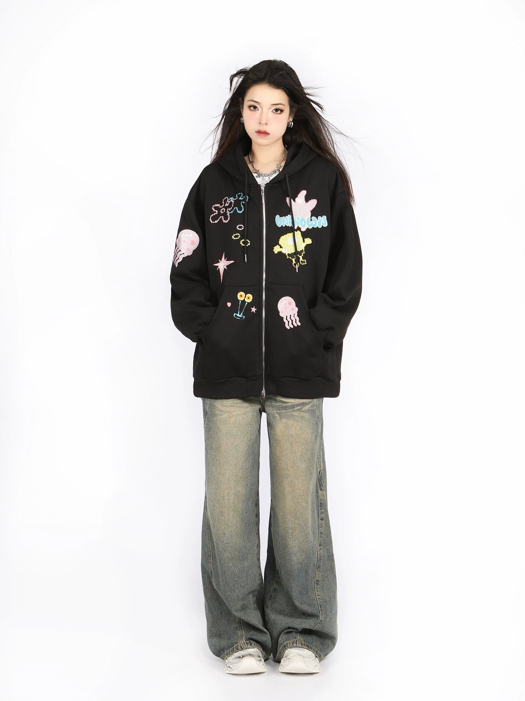 Against a plain white background, a person showcases their anime-inspired fashion with long dark hair, white sneakers, and baggy jeans while wearing Seakoff&