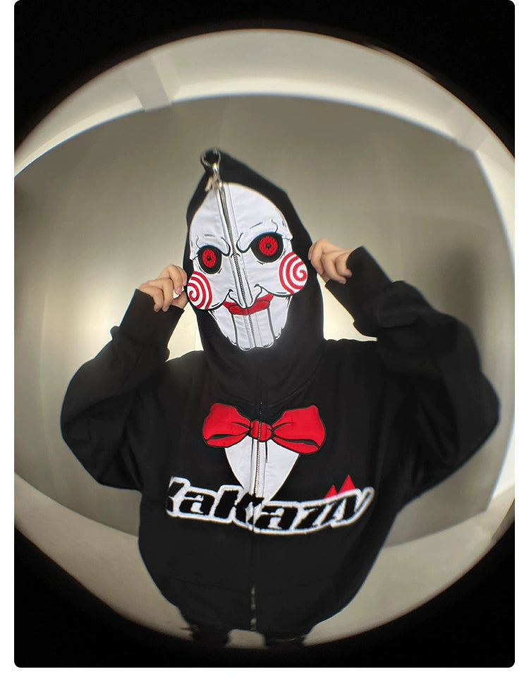 Someone wears a Seakoff Saw-Inspired Hoodie, a black oversized zip-up with Billy the Puppet&