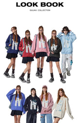 A Seakoff lookbook page showcases five models in the "Oh No! I Don’t Want to Work!" oversized graphic hoodies with a cute lazy cat design. Each hoodie is paired with black skirts, shorts, and casual sneakers. The page title reads: "LOOK BOOK SEAKOFF COLLECTION.