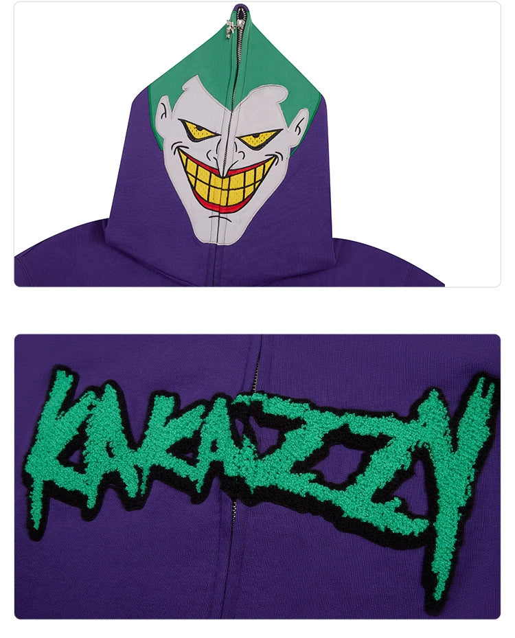 The Seakoff Joker-Inspired Hoodie is a purple oversized zip-up sweatshirt perfect for supervillain fans, featuring a vibrant cartoonish green and white face on the hood. Made from premium 400GSM cotton, it has "KAKAZZY" in bold stylized green lettering on the front.