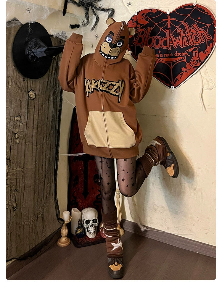 Dressed in a Seakoff Freddy-Inspired Hoodie, featuring a cartoon face and wide pocket, a person strikes a playful pose. They&