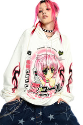 A person with pink hair confidently embraces the Y2K aesthetic in a Seakoff white hoodie, featuring a retro manga girl graphic. Paired with star-patterned wide-leg jeans and accessorized with a choker and chain, the plain backdrop highlights their bold, kawaii style.