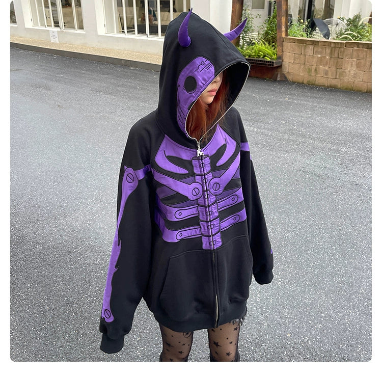 A person outdoors wears a Seakoff Dark Skull Demon Hoodie, an oversized black and purple anime-inspired zip-up sweatshirt with a horned hood, paired with star-patterned tights. The wet ground hints at recent rain.