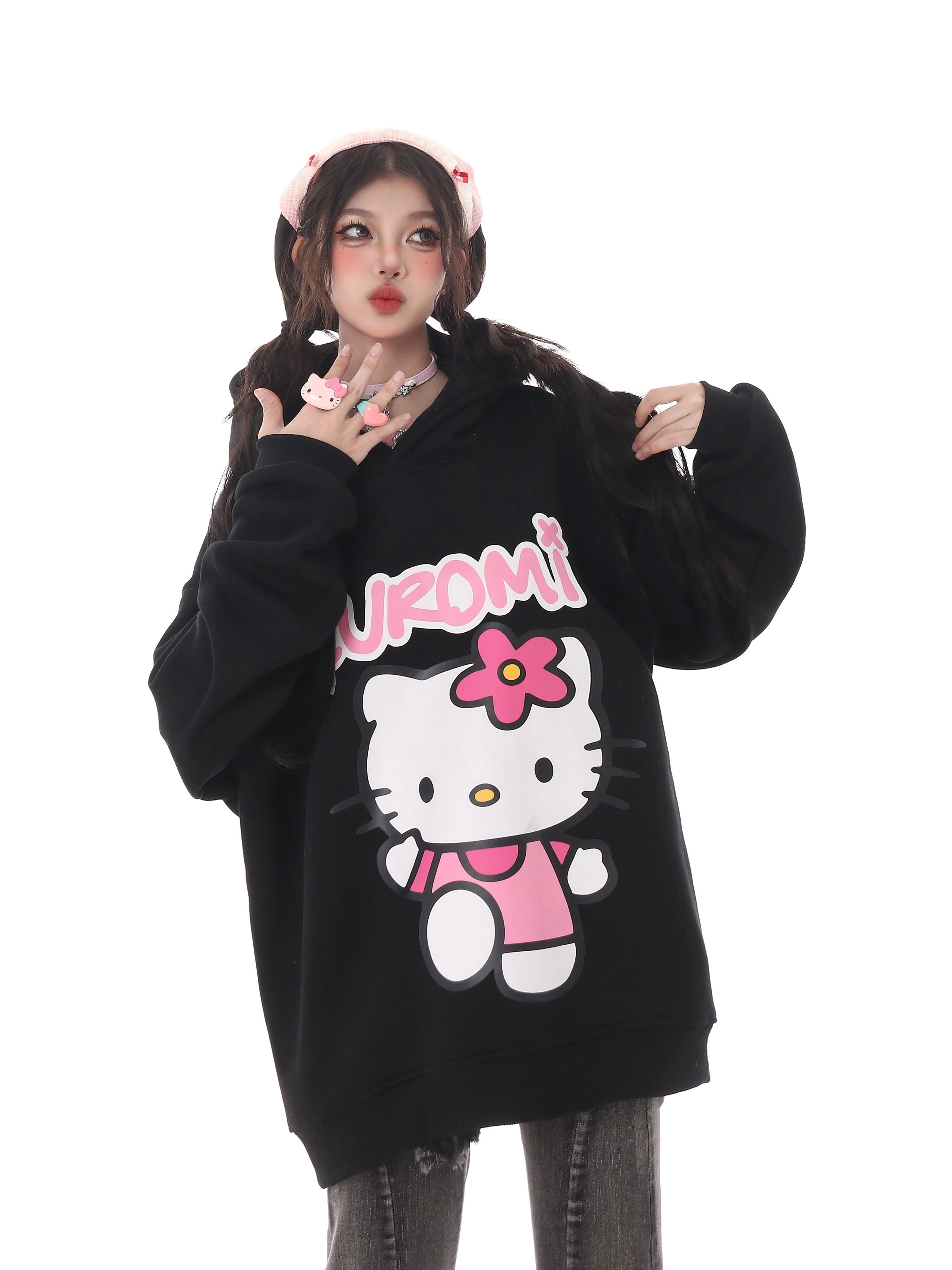 A person showcases a Seakoff black oversized hoodie, perfect for Sanrio fans, featuring Kuromi&